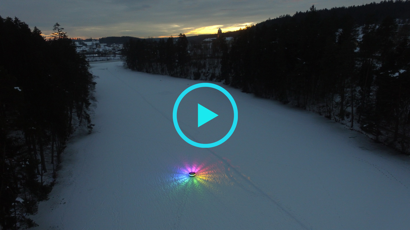 round artifact illuminating around with colors on an iced river